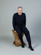 Man wearing a cashmere navy crew jumper and cashmere joggers in navy