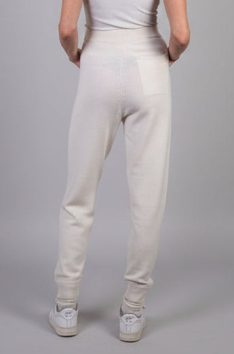 Woman wearing cream cashmere joggers 